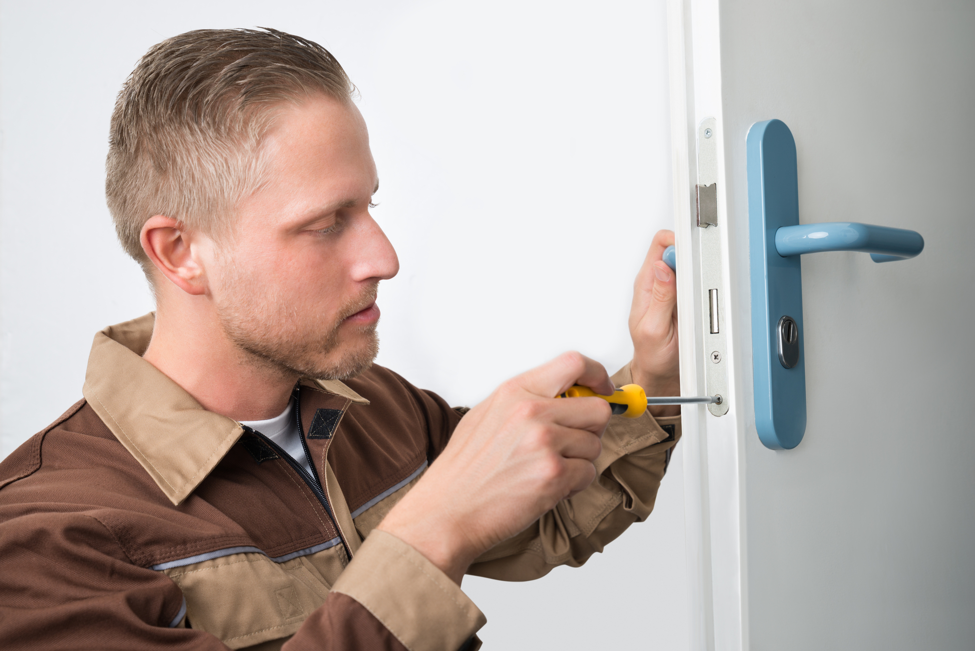 Portrait Young Male Carpenter Repairing Door Lock