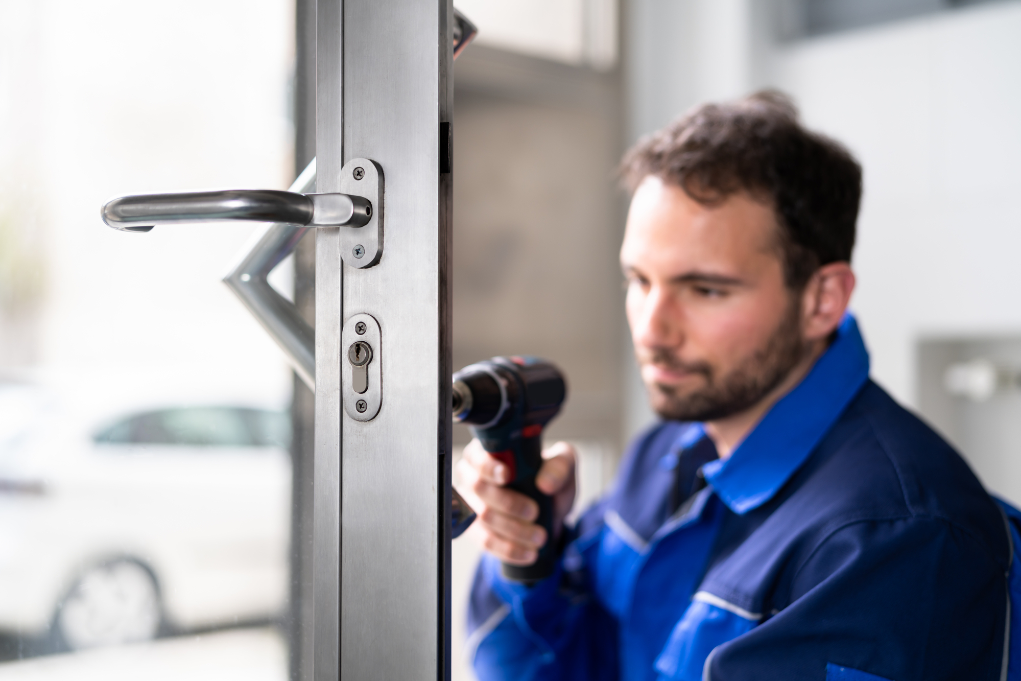 Locksmith Man Repairing And Changing Metal Door Lock